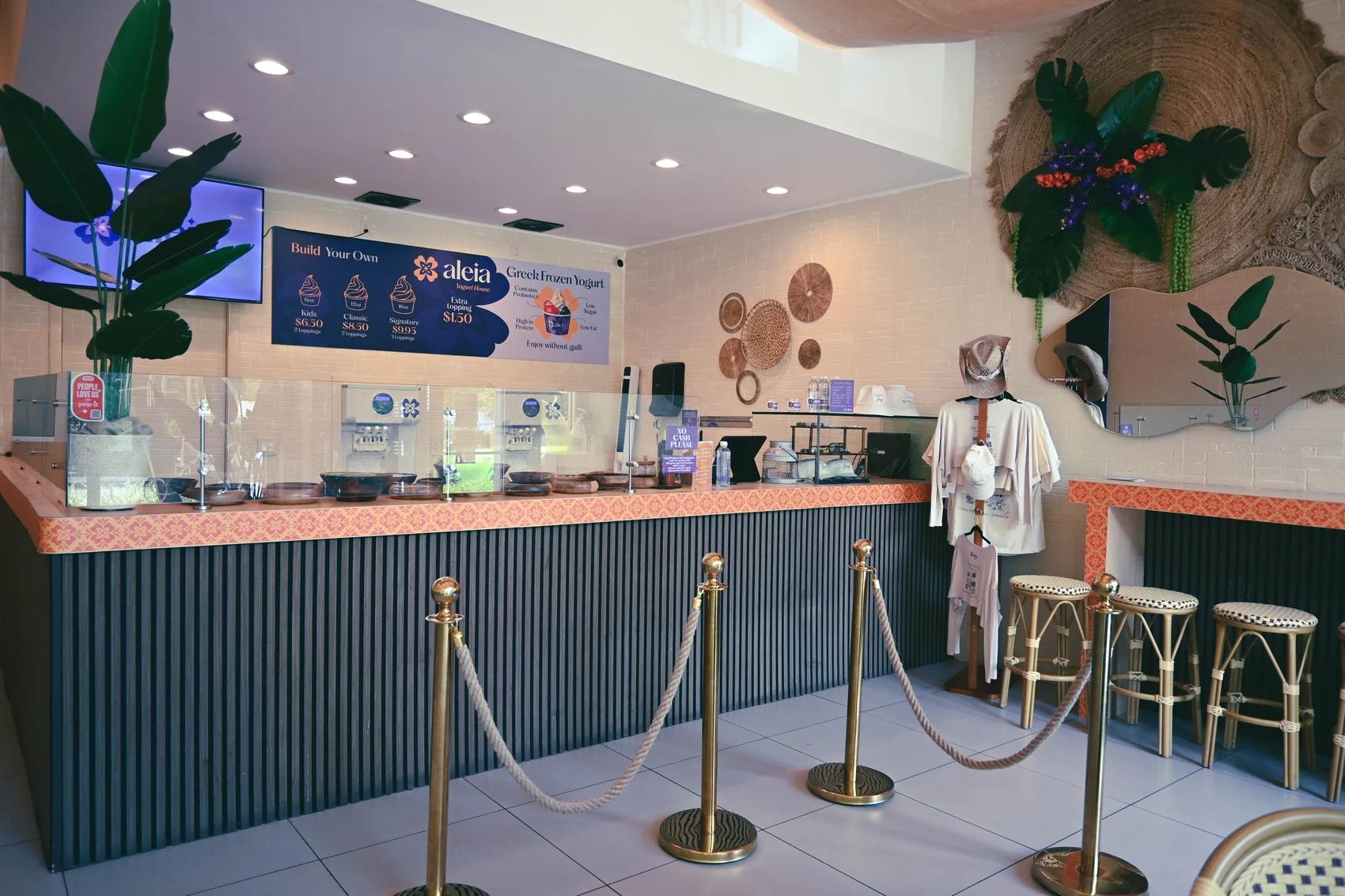 Inside aleia — the service counter under the menu board, with bar seating alongside