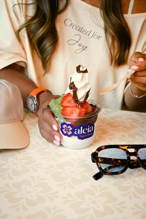 A guest being served at the aleia Yogurt House counter